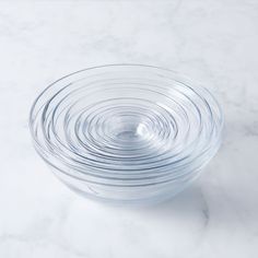 a glass bowl filled with water on top of a white counter