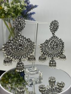 We bring beautiful Jewelry sure to elevate any look! Kindly pay attention to all photos and video and ask questions about the item prior to ordering. Festive Silver Chandelier Earrings With Tilla, Heavy Metal Chandbali Bridal Earrings, Silver Chandbali Chandelier Earrings With Stone Work, Traditional Metal Chandelier Earrings For Party, Silver Metal Chandbalis For Wedding, Heavy Chandbali Bridal Earrings, Silver Kundan Chandelier Dangle Earrings, Silver Chandelier Earrings With Stone Work For Party, Heavy Silver Chandelier Earrings For Festive Occasions