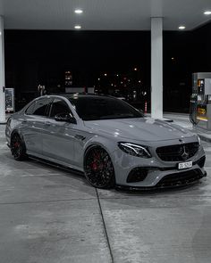 a silver car parked in front of a gas station