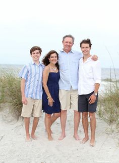 a family poses for a photo on the beach