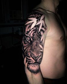 a man's arm with a tiger tattoo on it, and an arrow in the middle