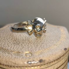 When ordering, please give us your phone number for safer Fedex shipping! RING SIZE:   12 US, 67 EU [FREE RESIZING] SILVER WEIGHT: 1.7 grams Unleash your inner pirate and make a bold statement with our Vintage Silver Skull Band Ring! This stackable piece is not just a ring, but a work of art that combines edgy aesthetics with intricate craftsmanship. The meticulously carved skull, adorned with crossbones, serves as a reminder of the fearless spirit within you. Made from high-quality silver, this ring promises durability and comfort without compromising style. Whether you're channeling your inner buccaneer or simply looking for a unique piece to add to your collection, the Vintage Silver Skull Band Ring is the treasure you've been seeking!    Your item will come boxed and wrapped carefully, Adjustable Skull Ring For Anniversary, Adjustable Round Skull Ring For Anniversary, Symbolic White Gold Skull Ring For Anniversary, Symbolic Skull Ring For Anniversary, White Gold Skull Rings For Gifts, White Gold Skull Rings As Gift, White Gold Skull Ring For Gift, White Gold Skull Ring As A Gift, Nickel-free Skull Rings For Gift