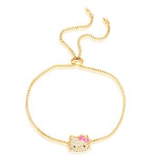 Elevate your style with the adorable charm of Sanrio's Hello Kitty in this officially licensed Yellow Gold Plated Pave Hello Kitty Face Lariat Bracelet. Crafted with exquisite attention to detail, this bracelet features a delicate lariat design with a stunning Hello Kitty face pendant. The pendant is adorned with sparkling pave-set crystals, adding a touch of elegance and glamour to your wrist.The bracelet is beautifully plated in yellow gold, providing a lustrous and luxurious shine. The adjust Hello Kitty Bracelet, Hello Kitty Face, Girly Bracelets, Hello Kitty Gifts, Face Pendant, Crystal Crafts, Jewelry Essentials, Bangle Bracelets With Charms, Stylish Gifts