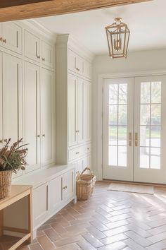 an empty room with white cabinets and baskets on the floor in front of it,