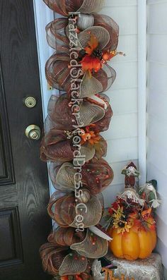 a tall stack of mesh wreaths sitting on top of a door