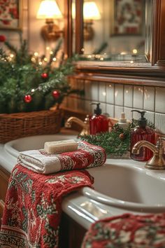 a bathroom decorated for christmas with candles and towels on the sink, along with other holiday decorations