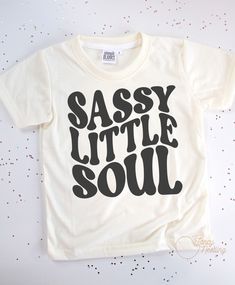 This sassy little soul kids t-shirt is made of 100% polyester, making it lightweight and breathable, perfect for active play. The material also helps keep colors bright, so your little one will always be looking stylish. *All tee brands run true to size. The graphic used on our tees are sublimation prints which means its printed into the fabrics on the shirt. No more peeling! *Care Instructions: Turn inside out & wash in cold. Lay Flat to dry. Do Not Iron. Sassy Graphic Tees, Toddler Girl Shirt Ideas, Basic T-shirt For Summer Playtime, Casual Tops With Custom Print For Playtime, Trendy Letter Print Tops For Playtime, Trendy White T-shirt For Playwear, Trendy Graphic Print T-shirt For Playwear, Casual T-shirt With Custom Print For Playtime, Toddler Girl Shirts Vinyl