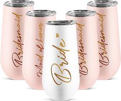 six pink wine tumblers with gold lettering on them