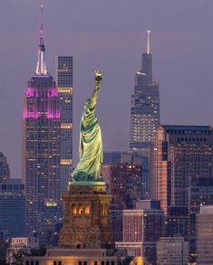 the statue of liberty is lit up in purple