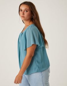 If you are looking for a simple, flattering blouse for work or school, look no further. The Curve Chiffon Flutter Sleeve Blouse is the ultimate smart-casual top. This top features short flutter sleeves, a button at the back of the neck, and a gathered hem at the bottom. The material is a non-stretchy chiffon that is lined except for on the sleeves. This blouse is made from 100% polyester and the lining is 95% polyester and 5% spandex. Hand wash cold. Imported. Model is wearing a size 1XL. Butterfly Sleeve Tops For Work, Butterfly Sleeve Tops For Workwear, Casual Butterfly Sleeve Tops For Workwear, Casual Tops With Butterfly Sleeve For Workwear, Casual Workwear Top With Butterfly Sleeves, Casual Workwear Blouse With Butterfly Sleeves, Versatile Flowy Short Sleeve Tops, Blue Flutter Sleeve Tops For Work, Blue Flutter Sleeve Tops For Workwear