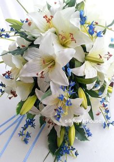 a bridal bouquet with white lilies and blue flowers