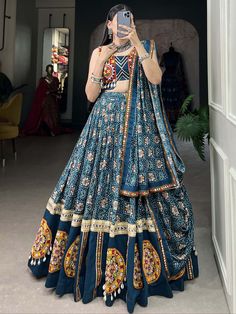 Elevate your traditional Indian festival look with our breathtaking blue bandhani printed rayon navratri lehenga choli! Crafted from high-quality rayon material, this stunning lehenga features a mesmerizing Gamthi Patch Work with delicate lace touch-ups for an elegant finish. The iridescent blue hue of the lehenga will surely make you the center of attention at any Navratri celebration.
The set includes a matching choli embellished with Gamthi Patch Work and lace detailing, along with a bandhani Blue Semi-stitched Bohemian Sets, Bohemian Blue Semi-stitched Sets, Unstitched Blue Bohemian Sets, Unstitched Bohemian Sets In Blue, Blue Bohemian Unstitched Sets, Blue Bohemian Sets Unstitched, Unstitched Bohemian Anarkali Set For Navratri, Blue Bohemian Sharara With Dupatta, Blue Semi-stitched Bohemian Sharara