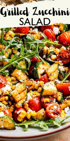 grilled zucchini salad with tomatoes, corn and spinach on a plate