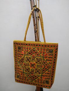 *Indian Embroidered Women Handmade Bag. *The interior of the bag is cotton and mirror work is done. *Very light weight and spacious. *Size Length 15 Inches(Approx), Width 15.5 Inches (Approx). *Please note that this is a handmade product and may have some slight imperfections,  please do not consider this as a defect. *Since the size above is measured by hand, the size of the actual item you receive could be slightly different from the size above. *Actual colors may vary a little from those shown due to the nature of photography and individual monitor color settings. *Custom and Import Taxes :        Buyers are responsible for any customs and import taxes that may apply.  Saaksha isn't responsible for delays due to customs. *Our items are shipped through India Post with the service of Regi Embroidered Rectangular Shoulder Bag For Festivals, Rectangular Embroidered Shoulder Bag For Festivals, Cotton Bags With Multicolor Embroidery, Traditional Cotton Shoulder Bag For Daily Use, Yellow Embroidered Bag For Daily Use, Traditional Multicolor Cotton Shoulder Bag, Rectangular Cotton Bags With Multicolor Embroidery, Yellow Embroidered Shoulder Bag For Daily Use, Traditional Embroidered Rectangular Shoulder Bag