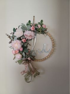 a wreath with flowers hanging on the wall