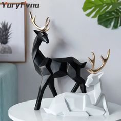 two black and white deer figurines sitting on top of a table