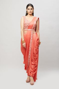 Modern, fun and chic! This readymade coral dhoti saree with multi-resham embroidery is perfect for any bridal event! Fabric: Satin silk Ready to Ship Occasion: Sangeet, Mehendi Events WASH CARE INSTRUCTIONS - Please Dry clean only when it is applicable. Slight color variation is possible due to digital photography. Jewelry not included Embroidered Draped Lehenga For Wedding, Embroidered Draped Traditional Wear For Diwali, Embroidered Draped Traditional Wear For Wedding, Embroidered Draped Traditional Wedding Wear, Embroidered Draped Dupatta For Diwali, Traditional Draped Wear With Resham Embroidery For Eid, Traditional Pink Draped Lehenga, Traditional Draped Pink Lehenga, Traditional Chanderi Draped Dupatta