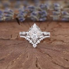 an engagement ring on top of a piece of wood