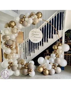 some white and gold balloons are on the stairs