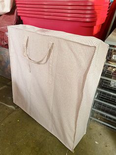 a large white bag sitting on top of a pile of red boxes