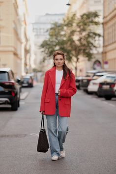 Red single-breasted wool jacket featuring a relaxed fit, with a classic collar and lapels, long rolled-up sleeves, and front patch pockets with flaps. Secured with two buttons. This design is inspired by the 'men's shoulder' style, adding a touch of masculinity to your look. Not only is it on-trend, but it also serves as a versatile base for any outfit. The jacket's generous cut and wide shoulders make it perfect for layering oversized sweatshirts or sweaters underneath, allowing for comfortable movement. Model measurements: Height - 175 cm (5'9"ft) Bust - 82 cm (32.3 in) Waist - 61 cm (24 in) Hips - 92 cm (36.2 in) 🧶Details 40% Wool, 40% Acrylic, 20% Polyamide Lining: Viscose Model wears a size S 📏Product Size Chart: S (US 4-6) 1/2 Bust - 52 cm | 20.4 in 1/2 Hip - 52 cm | 20.4 in Back L Red Wool Blazer Outfit, Classic Red Wool Coat, Red Oversized Wool Outerwear, Oversized Red Wool Outerwear, Red Wool Oversized Outerwear, Modern Red Outerwear For Work, Red Wool Coat For Spring Workwear, Classic Red Workwear Outerwear, Classic Red Outerwear For Work