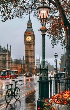 the big ben clock tower towering over the city of london, england in the rain