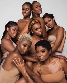 six black women posing for the camera with their arms around each other