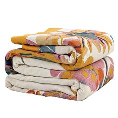 three blankets stacked on top of each other in different colors and patterns, with one folded up