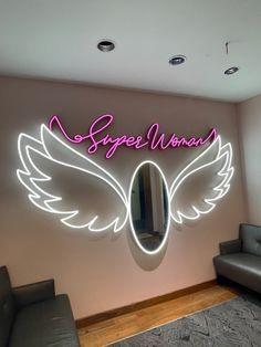 a neon sign that says speed woman on the side of a wall next to a couch