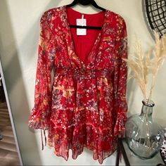 Free People Dress Red Floral Print Mini Dress For Casual Occasions, Red V-neck Mini Dress For Dress Down Occasions, Casual Red V-neck Mini Dress, Flowy Red Midi Dress For Fall, Red Flowy Dress For Spring, Flowy Red Dresses For Spring, Bohemian Red Mini Dress With Ruffles, Red Mini Dress For Brunch, Red Floral Print Dress For Brunch