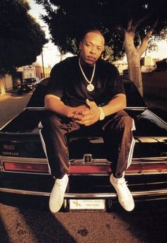 a man sitting on the hood of a car