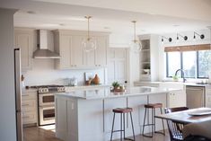 the kitchen is clean and ready to be used for cooking or eating, with stools around the island