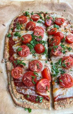 a pizza with tomatoes and cheese cut into slices