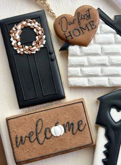 decorated cookies are sitting on a table with the words welcome written in black and white