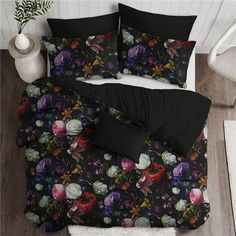 an image of a bed with black and purple floral comforter sets on the floor