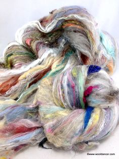 multicolored skeins of yarn sitting on top of each other