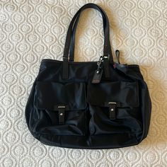 Great Condition Authentic Tumi Bag, No Stains, Tear Or Wear. Leather Straps, Multiple Compartments, Luggage Tag Strap To Secure Over Luggage Handle. Great For Travel Or Work As It Fits Up To A 16 Inch Laptop Too! (Computer Mouse For Size) 16” X 13” X 5” Elegant Nylon Tote Shoulder Bag, Elegant Nylon Tote Bag, Elegant Nylon Shoulder Bag For Shopping, Black Nylon Shoulder Bag For Errands, Black Nylon Bags With Leather Handles, Elegant Nylon Bag For Everyday Use, Elegant Everyday Nylon Bag, Elegant Nylon Bag For On-the-go, Elegant Nylon Bag With Adjustable Strap