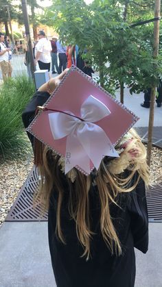 Graduation Cap with bling and bow Bow Cap Graduation, Cap Decoration Ideas College, Cap And Gowns Decoration Ideas, Cheerleader Graduation Cap, Pink Girly Graduation Cap, Grad Cap Sparkle, Cap Decoration Graduation Kindergarten, K-12 Melanie Martinez Graduation Cap, Simple Cap Designs