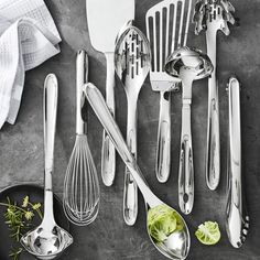 kitchen utensils are lined up on a table