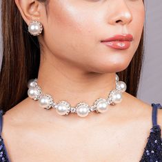 With this Manish Malhotra Jewelry Inspired Pearl diamond necklace, you can try to recreate Princess Diana's timeless elegance. Embrace sophistication with this Pearl Statement Necklace inspired by Princess Diana's iconic style. Choose the Pearl Choker or Pearl Bridal Necklace for a classic and refined look. These exquisite pieces combine the lustrous beauty of pearls with the sparkle of diamonds, adding a touch of regal charm to any bridal ensemble. *𝐏𝐑𝐎𝐃𝐔𝐂𝐓 𝐃𝐄𝐓𝐀𝐈𝐋* * Material: Brass * Plating: White Rhodium Plated * Stone: AAA-quality CZ diamond & Pearls. *𝐃𝐈𝐌𝐄𝐍𝐒𝐈𝐎𝐍𝐒*  Necklace * Weight: 56 gm * Length: 8.5 Inches * Width: 0.7 Inches * Height: 0.6 Inches  Earrings * Weight: 7 gm each * Length: 0.6 Inch * Width:  0.6 Inches * Closure: Push Back *𝐒𝐇𝐈𝐏𝐏𝐈𝐍𝐆 𝐏𝐎 Bride Pearl Necklace, Pearl Diamond Necklace, Necklace Luxury, Bridal Pearl Necklace, Pearl Statement Necklace, Pearl And Diamond Necklace, Pearl Necklace Wedding, Pearl Necklace Set, Diamond Choker