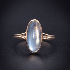 A stone believed to aid in new beginnings, Moonstone is also attributed with inner growth and emotional stability. A stone connected with intuition and femininity, it has been admired for centuries. Converted from an antique cufflink using an antique stick pin to make the shank, this beauty has a simple elegance and a mesmerizing oblong moonstone. Wear this ethereal gem anywhere-she looks just as fabulous with jeans and a tee as she does with a black velvet dress! Details (approximate) Size: 6.5 Dimensions: Ring top is 1.2 cm at widest point. Weight: 1.7 grams Materials: Gold, Moonstone Metal: 14K yellow gold Marks: Marked 14K, SW on original element. Condition: Very good converted antique condition commensurate with age. This piece can be resized, resize options are $25 more than the base Timeless Oval Cabochon Jewelry, Timeless Round Moonstone Ring, Formal Moonstone Cabochon Ring, Antique Oval Cabochon Opal Ring, Antique Opal Ring With Oval Cabochon Gemstone, Timeless Moonstone Ring For Formal Occasions, Antique Opal Ring With Oval Cabochon, Timeless Formal Moonstone Ring With Polished Finish, Heirloom Oval Moonstone Ring