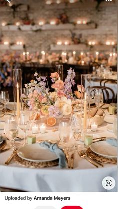 an image of a table setting with flowers and candles in the center, on instagram