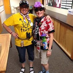 two women standing next to each other in a hallway