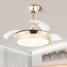 a ceiling fan with two white blades on it in a living room or dining room