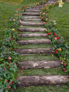 a set of stairs made out of logs and flowers