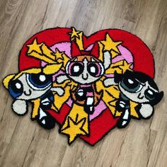 the rug is shaped like a heart with three cartoon characters on it, and has been drawn