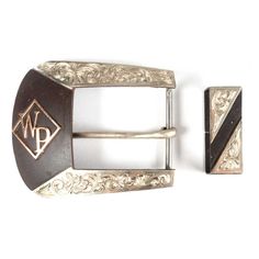 a pair of silver and black belt buckles