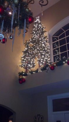 a decorated christmas tree hanging from the ceiling