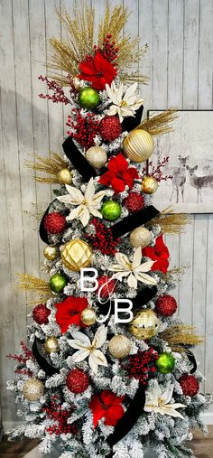 a christmas tree decorated with red, white and gold ornaments