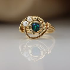 There is nothing ordinary about this handmade wrap ring. Set with a beautiful Atlantic Opal that goes well with any outfit. ☆ WHY THIS PIECE OF J E W E L R Y IS AWESOME! ☆ * Hand finished and made from high quality raw materials * Long lasting beauty & Timeless design * Set with a Atlantic Opal 5 mm, Fresh water pearls and a gold plated bead ♡ WRAPPING ♡ * All 23 Summers jewels arrive in a cute pouch or gift box so they are gift ready. DELIVERY ✉ * Most items are ready made but some are made Cute Wire Rings, Bead Wrapping, Wire Jewelry Patterns, Wire Jewelry Rings, Wire Wrap Jewelry Designs, Ring Pearl, Ring Wire, Wire Jewelry Tutorial, Diy Jewelry Inspiration